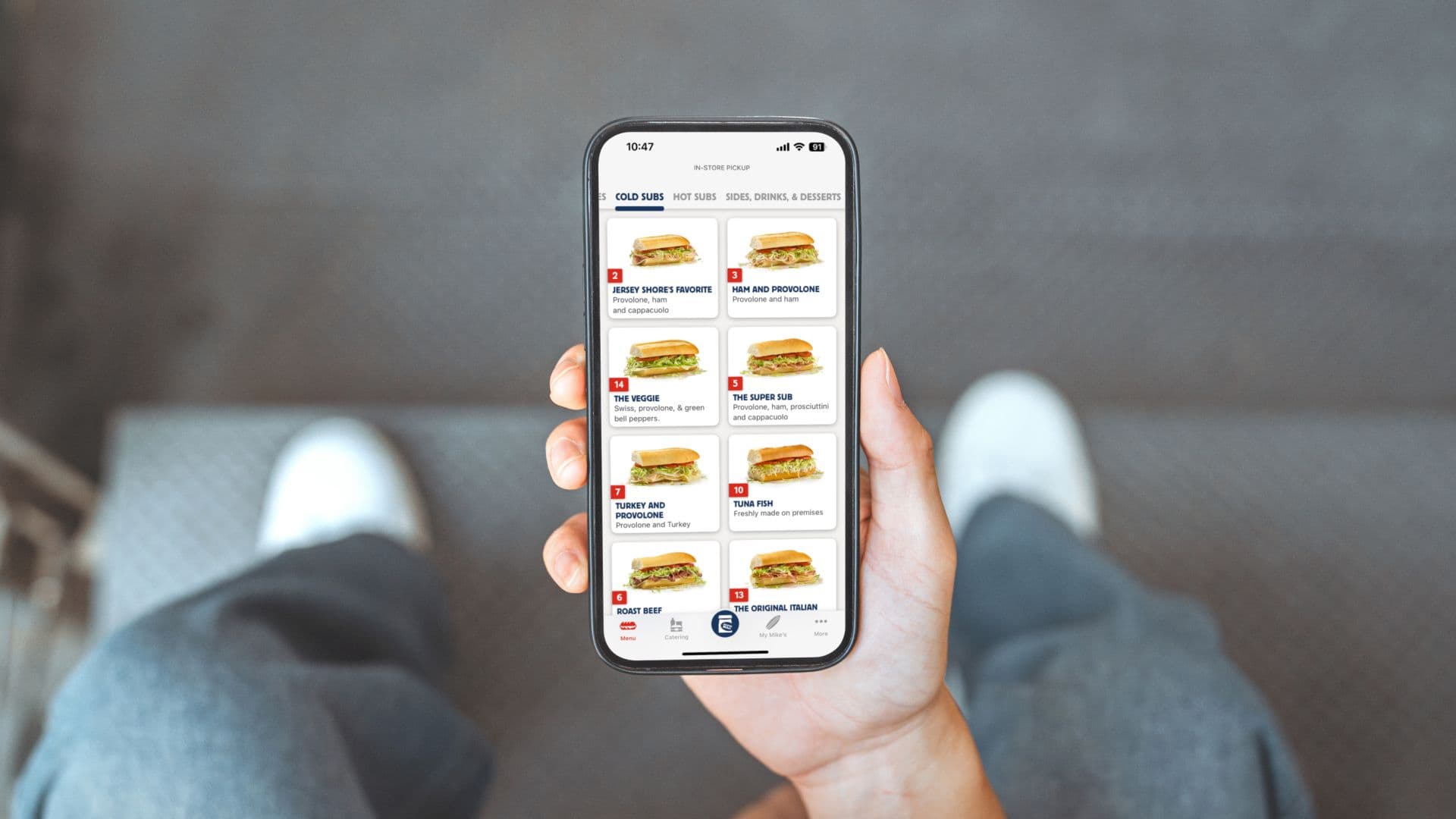 Person holding a phone with the app open