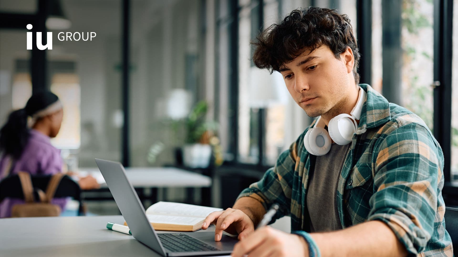 Student working on laptop in a classroom
