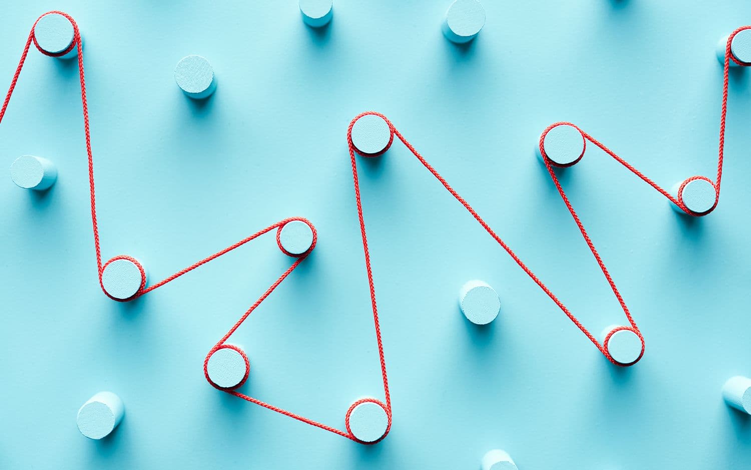 Pegs on blue background with a string connecting some of them