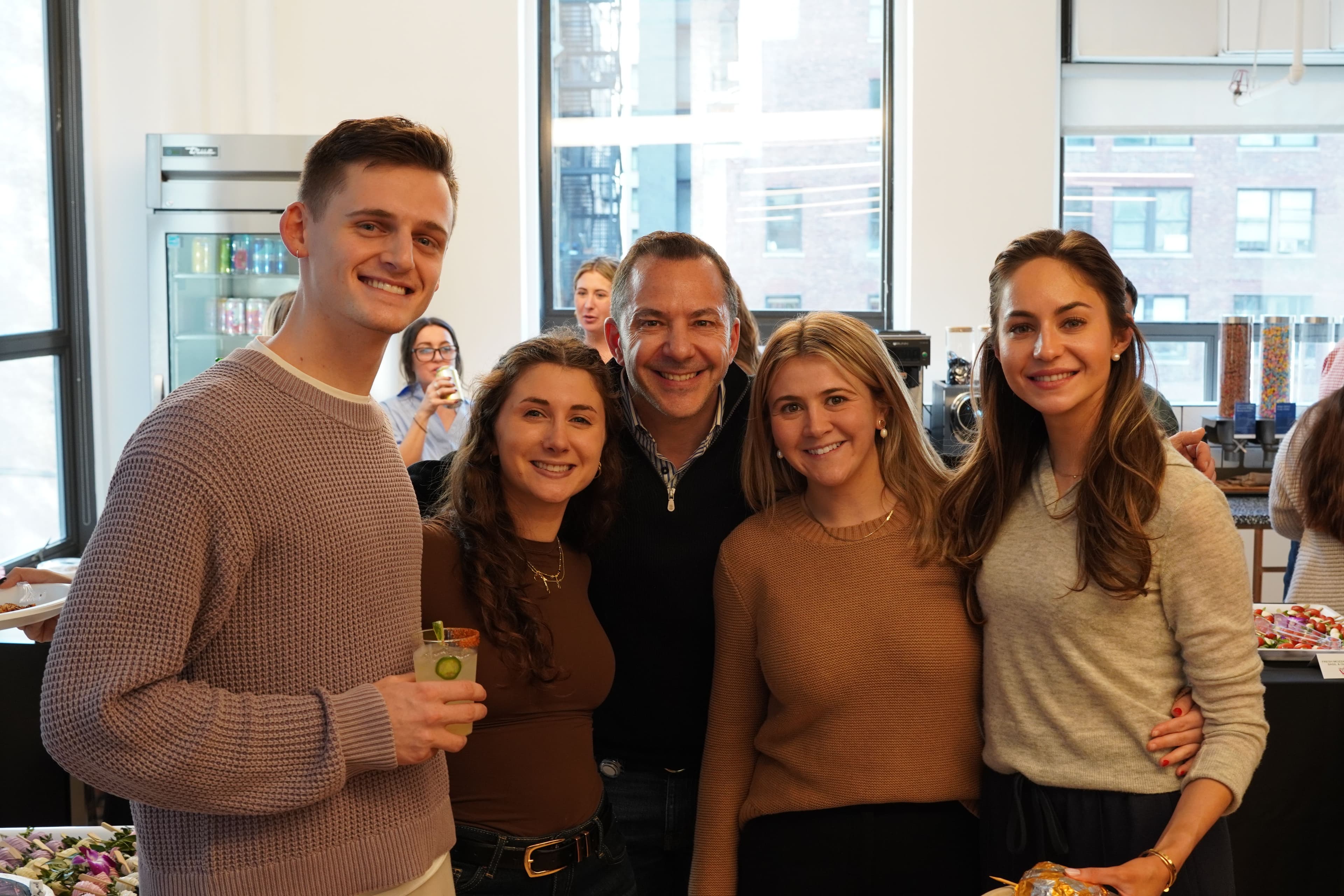 A group of Ampliteers smile in the new window-filled office