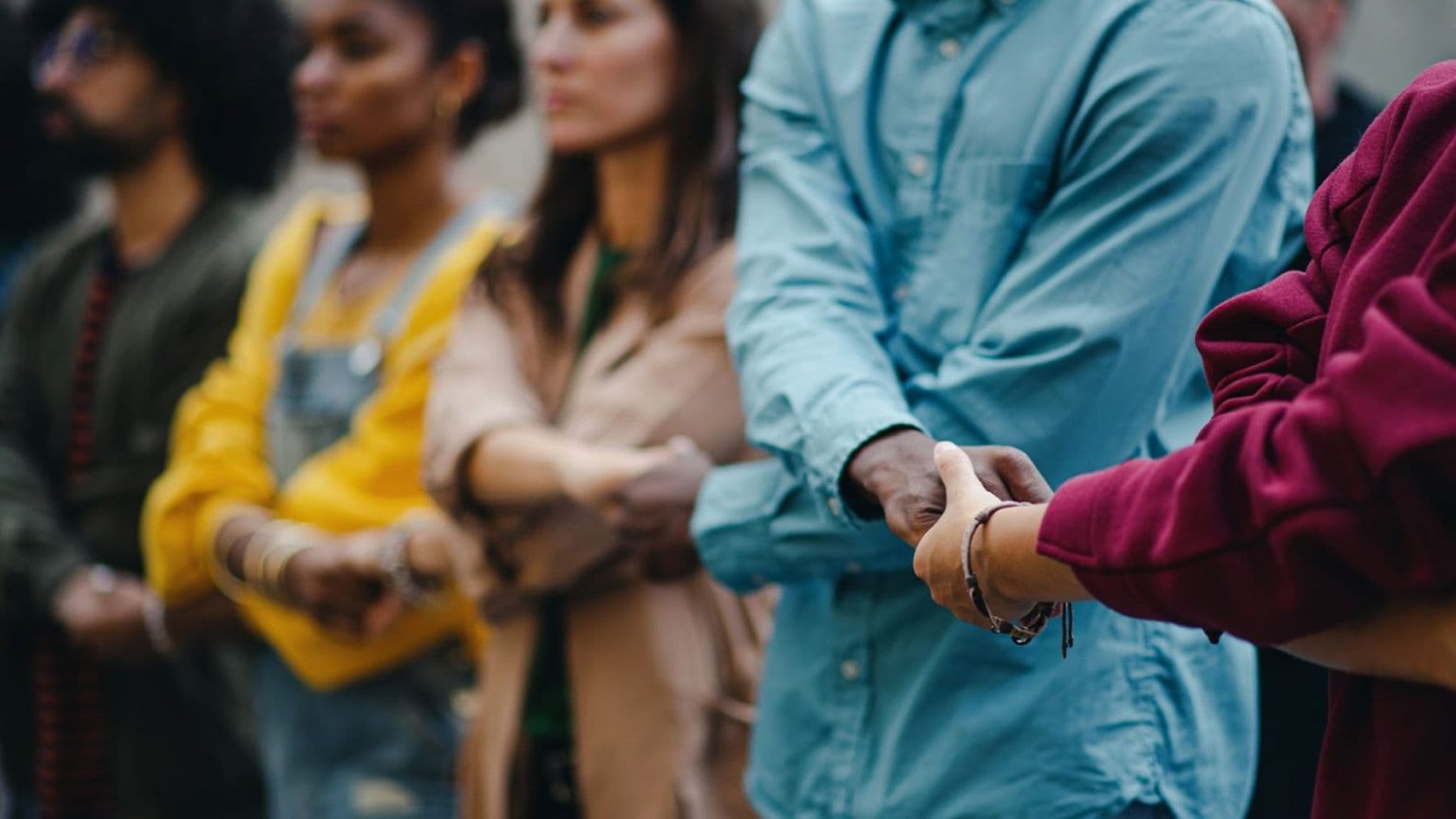 People standing together while holding hands
