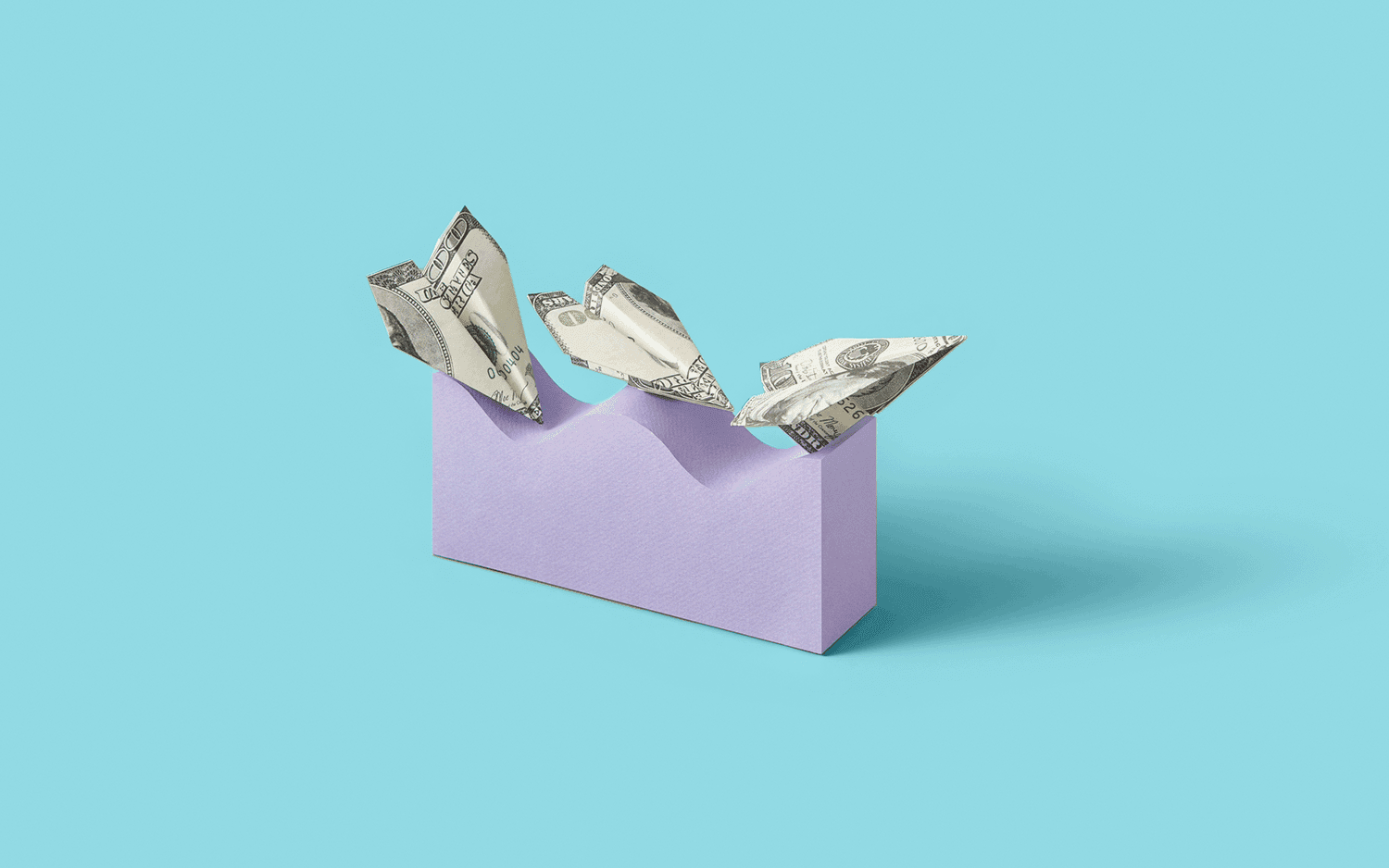 A wave of hundred-dollar-bill paper planes on a blue field