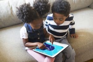 Kids playing with one of Tiny Bop's educational games, The Human Body.