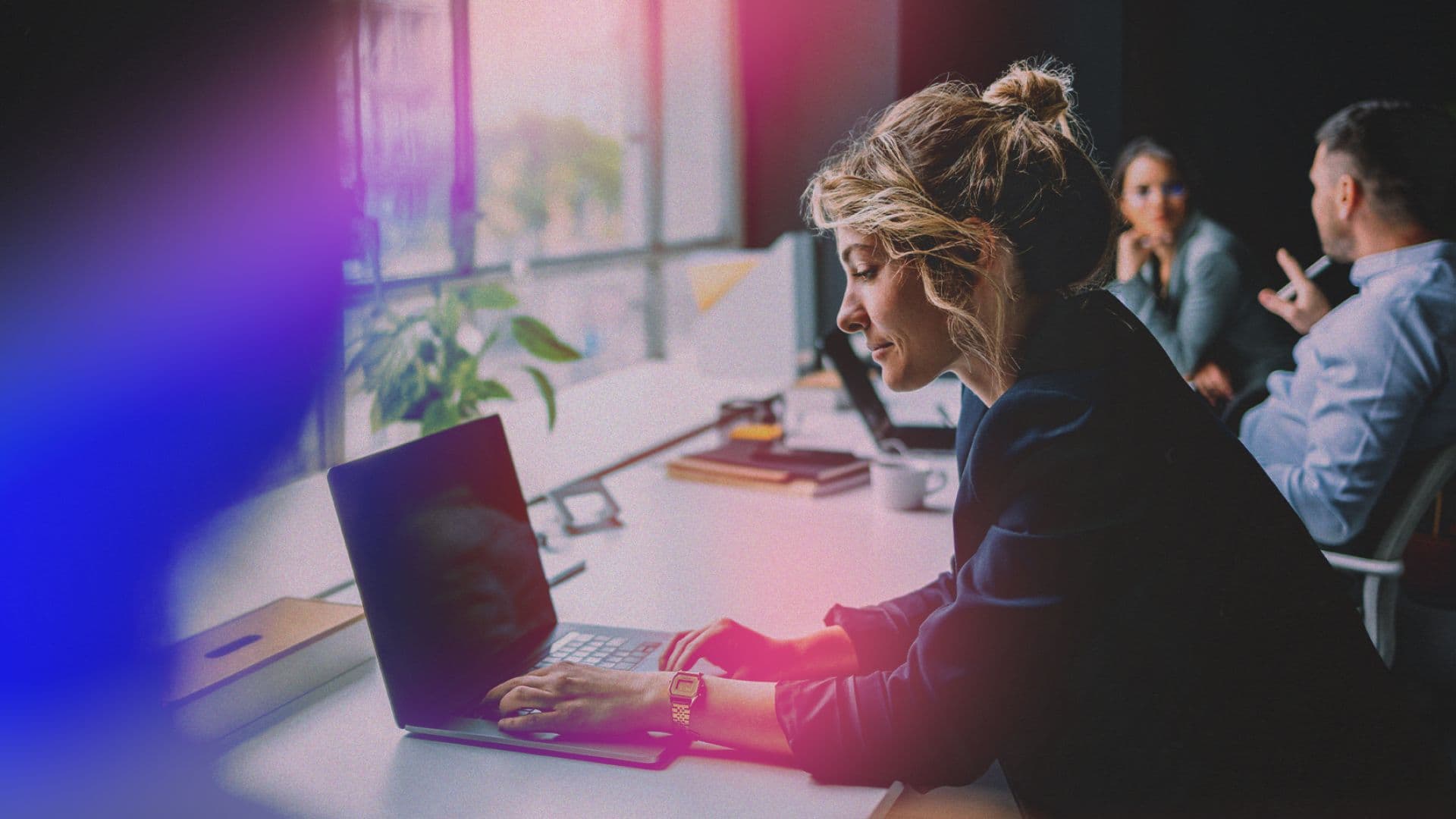 woman working at laptop by window