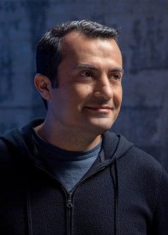 person focusing to the right smiling