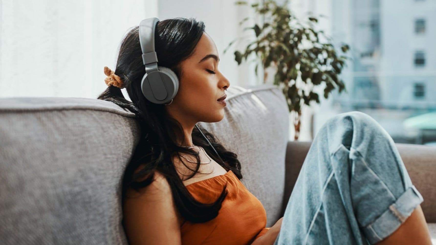 A girl listening music with the headphones on her head