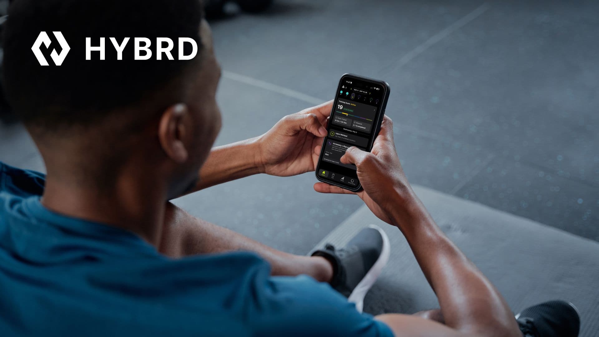 A man looking at the HYBRD app on his phone.