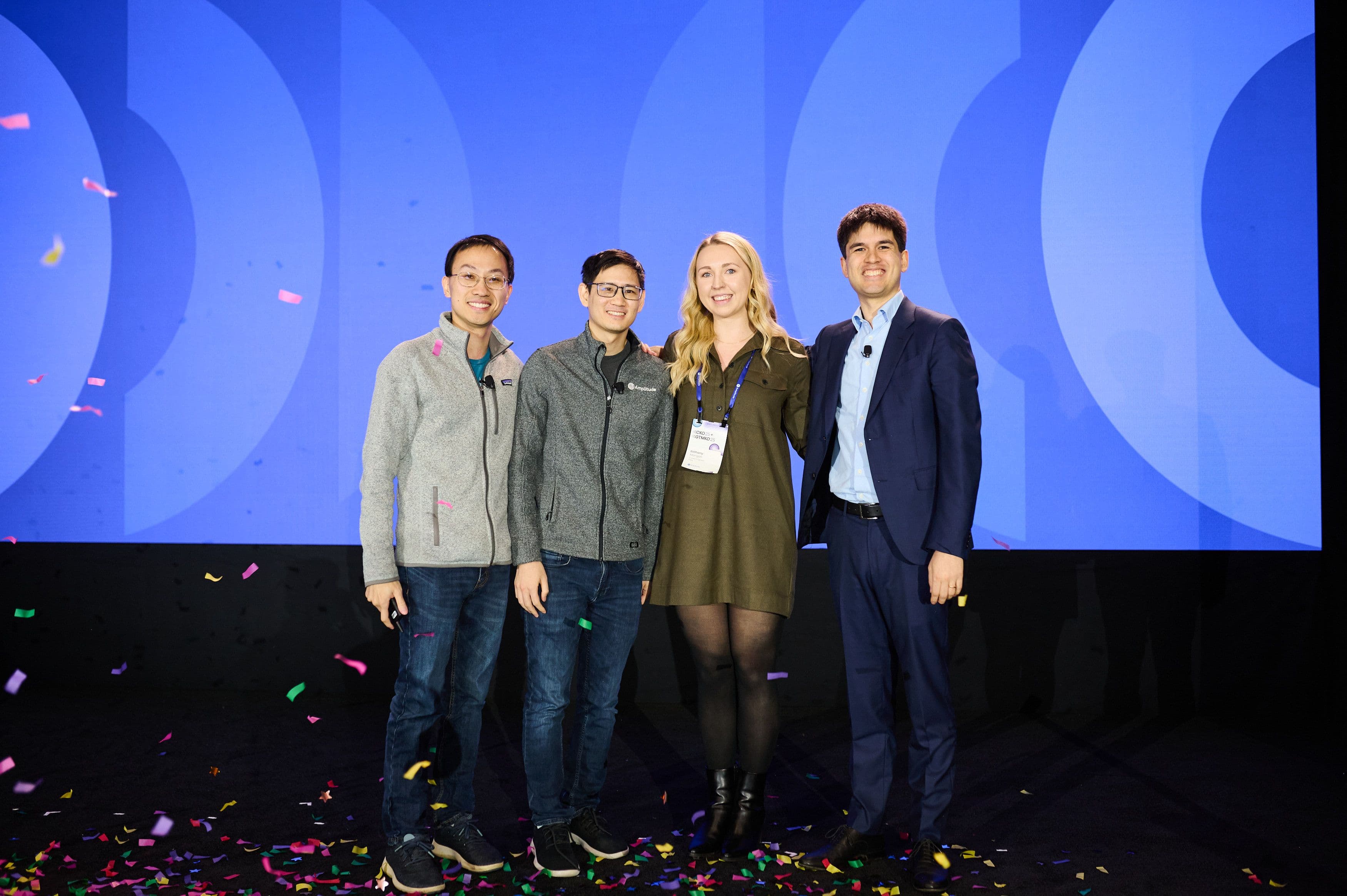 Bethany Mangan accepting her Founders' Award from Amplitude cofounders Jeffrey Wang, Curtis Liu, and Spenser Skates